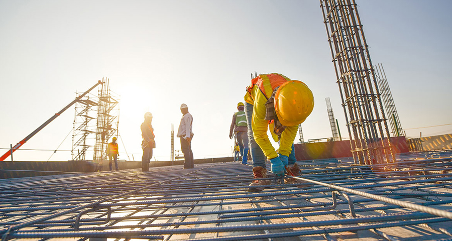 Construction workers fabricating steel reinforcement bar at the